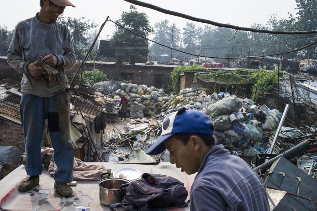 Chinese labourers sorting out metal for recycling in Dong Xiao Kou village, on the outskirt of Beijing. Photo: AFP