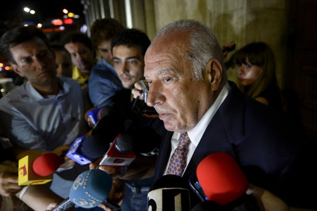 In this photo taken in August 2014, Dan Voiculescu, a Romanian media mogul, speaks after being sentenced to 10 years in jail for corruption. He has since penned eight scientific papers, potentially shortening his sentence. Photo: AP