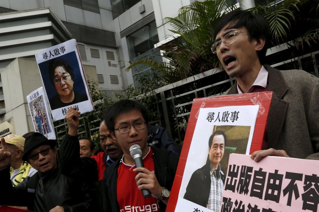 Pro-democracy demonstrators hold up portraits of Causeway Bay Books shareholder Lee Bo during a protest to call for an investigation behind the disappearance of five staff members of a Hong Kong publishing house and bookstore, outside the Chinese liaison office in Hong Kong. Photo: Reuters