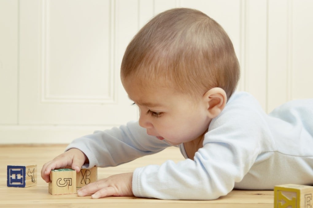 Babies who play with traditional toys such as wooden building blocks communicate better. Photo: Corbis