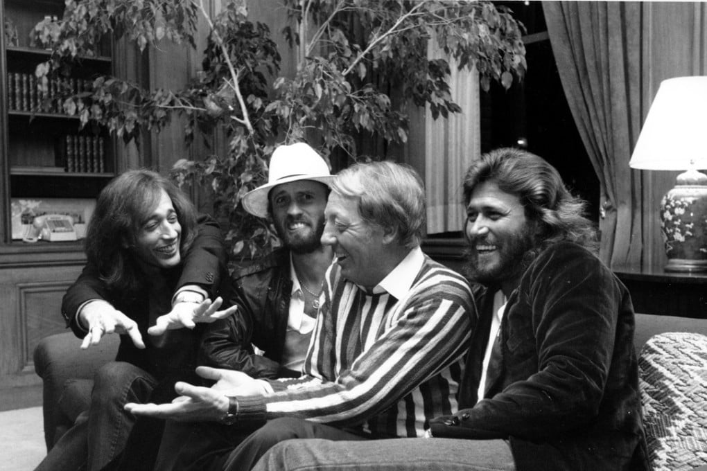 Robert Stigwood (centre) with the Bee Gees in New York City in 1981. Photo: AP