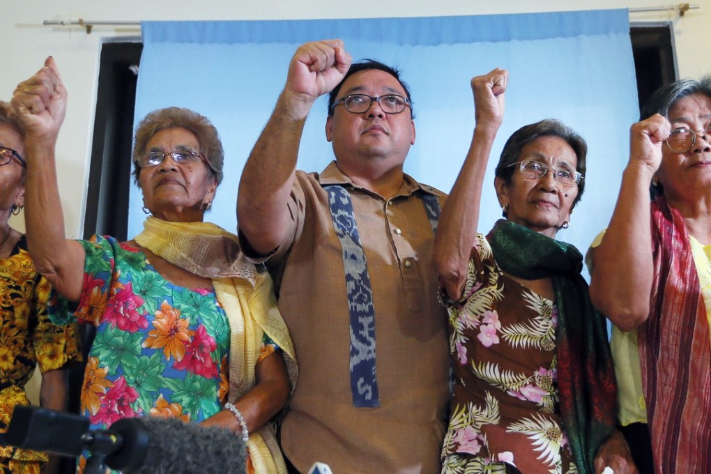 Four of the remaining 32 alleged Philippine sex slaves with their legal counsel Harry Roque (centre). Photo: AP