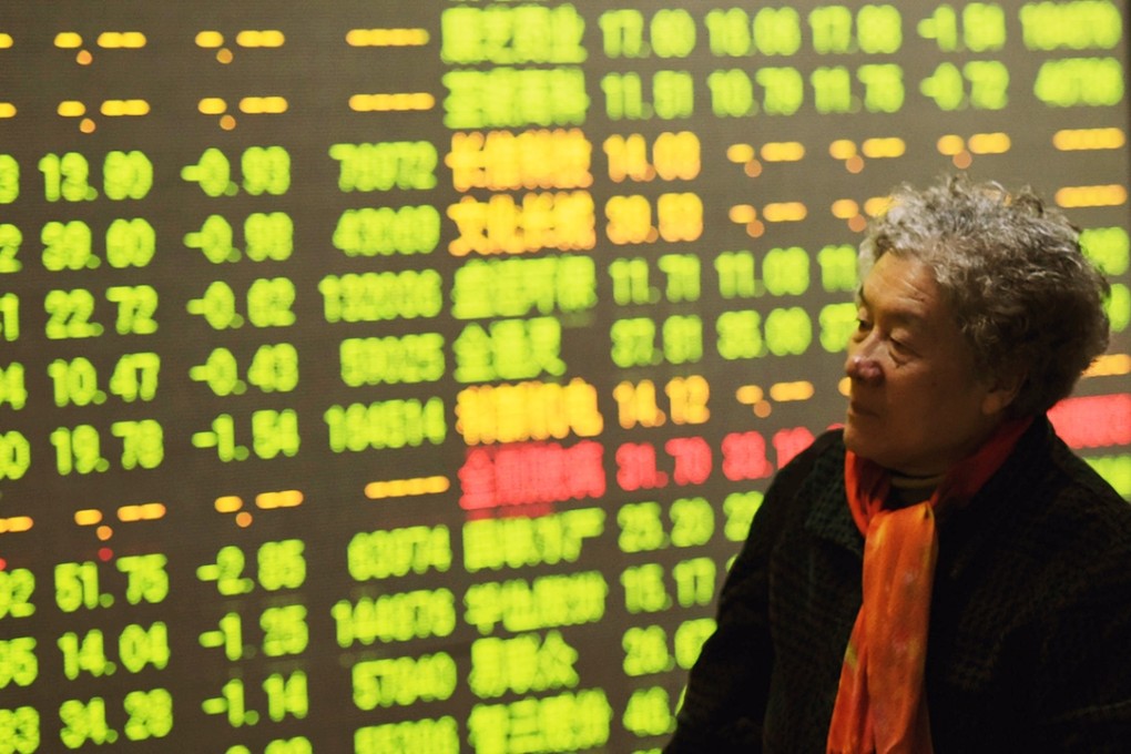 An elderly investor looks on with concern at the stock chart board at Shanghai this morning. Photo: Xinhua