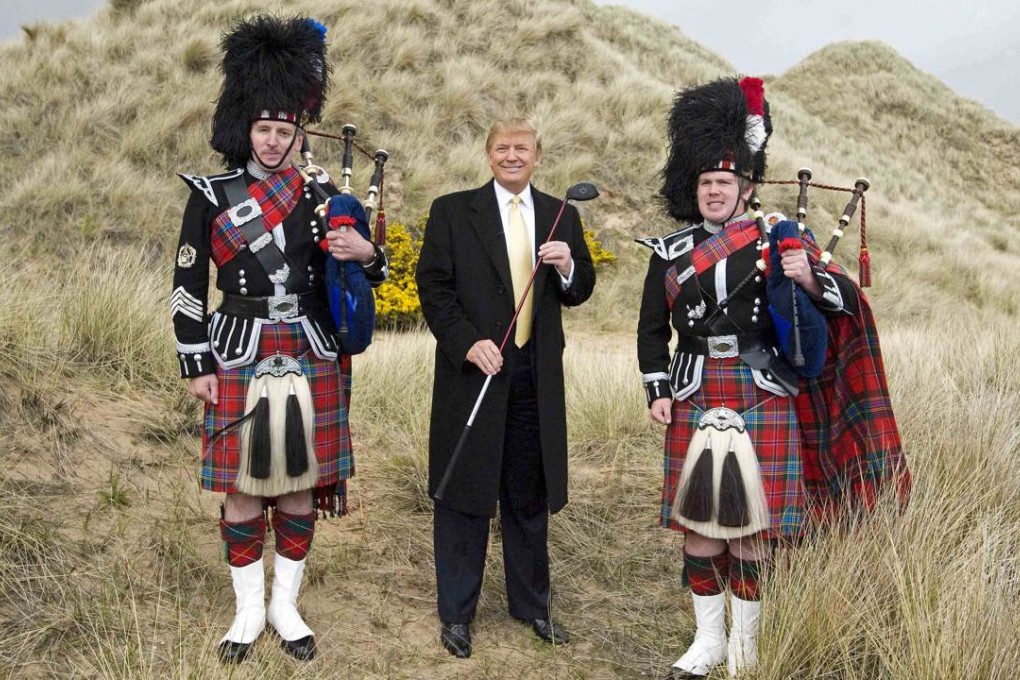 A photo taken on May 27, 2010, shows US tycoon Donald Trump posing with Scottish pipers during a visit to the construction site of his golf course on the Menie Estate near Aberdeen, Scotland. Photo: AFP
