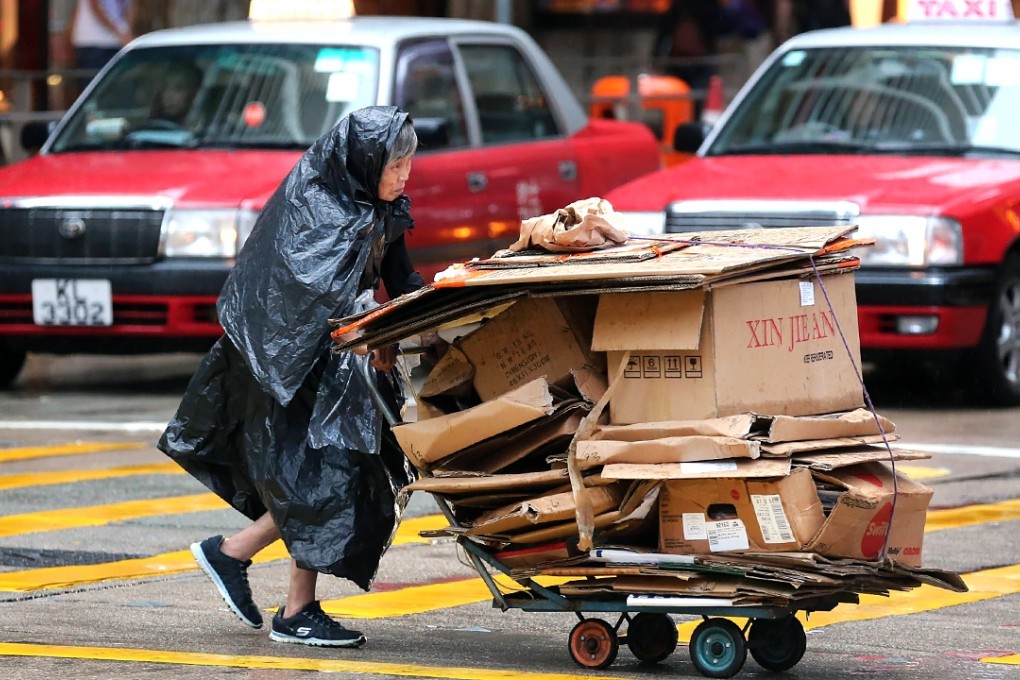 An elderly woman collects cardboard for recycling to make a living. Photo: Edward Wong
