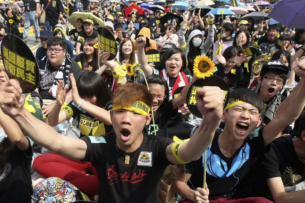 Demonstrators taking part in the Sunflower movement shout slogans in front of the Presidential Office in Taipei in 2014. Young Taiwanese are much more politically active than their forbears. Photo: Reuters