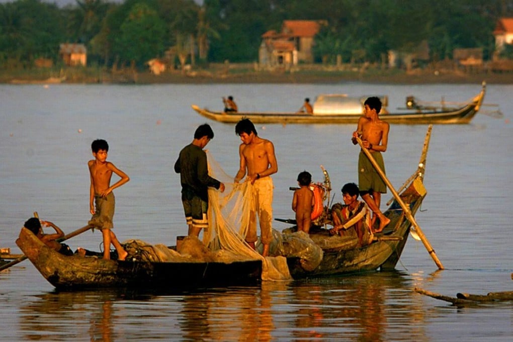 Cambodian men and boys fish from their boat on the Mekong River in Phnom Penh. Photo: AP