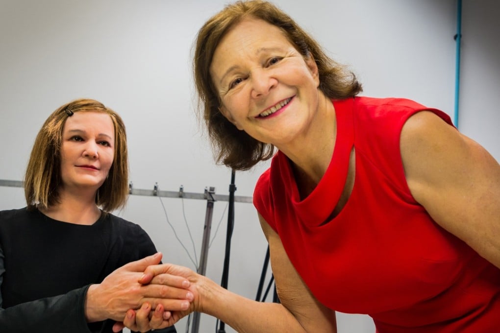 Professor Nadia Thalmann (right) shaking hands with Nadine, a robot made in her likeness at a Singapore university.