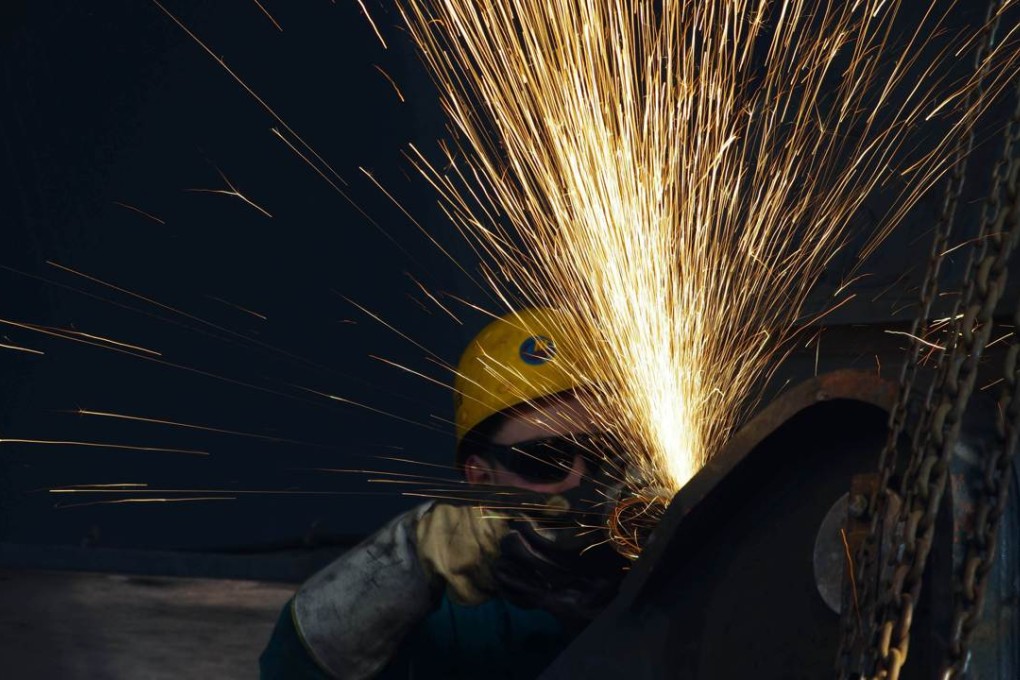 A worker polishes steel in a factory in Rizhao, Shandong province. Photo: AFP