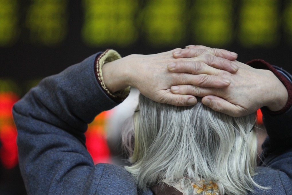 Investors check stock prices at a securities brokerage house in Beijing on Friday. Photo: Simon Song