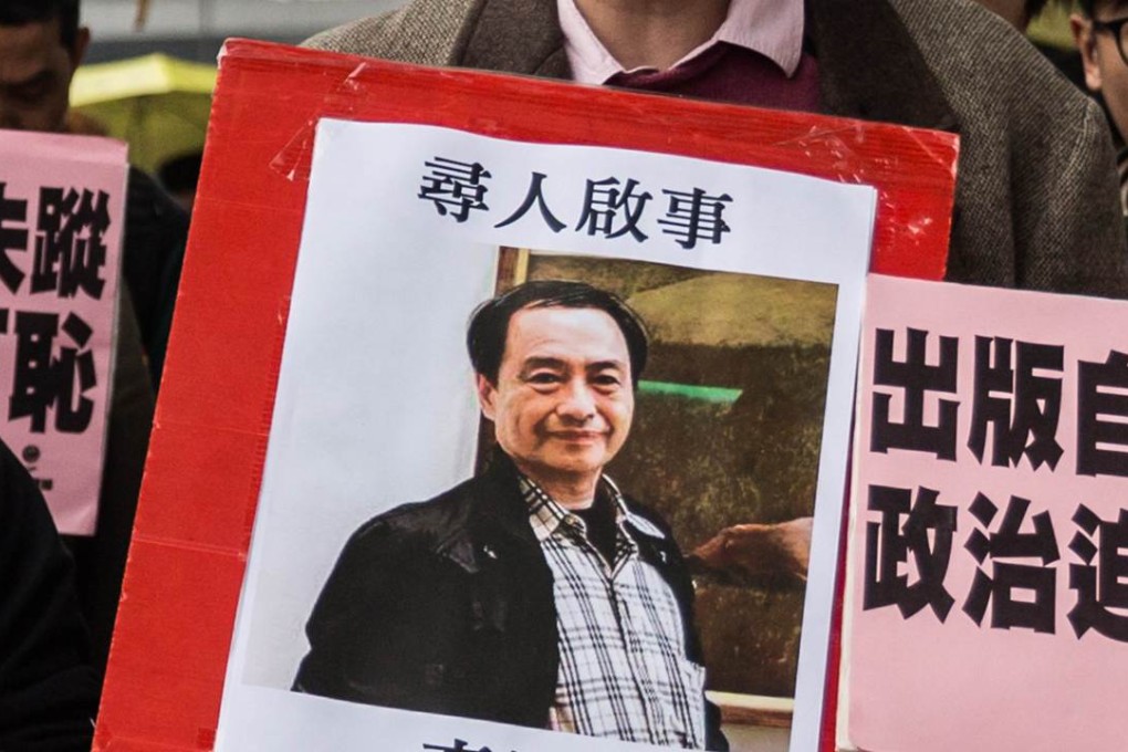 A protester in Hong Kong holds up a missing person notice for Lee Bo. Photo: AFP