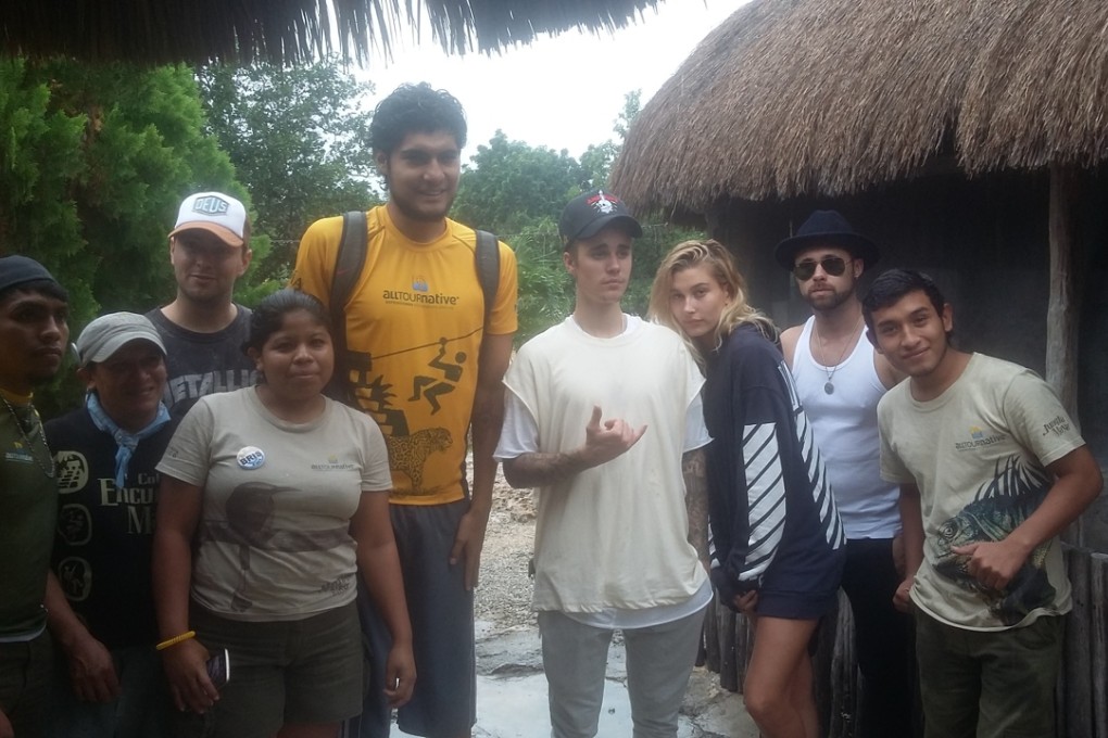 Justin Bieber and unidentified members of his entourage pose for a photo with Jungla Maya Park employees. Photo: All Tour Native Expeditions/AP