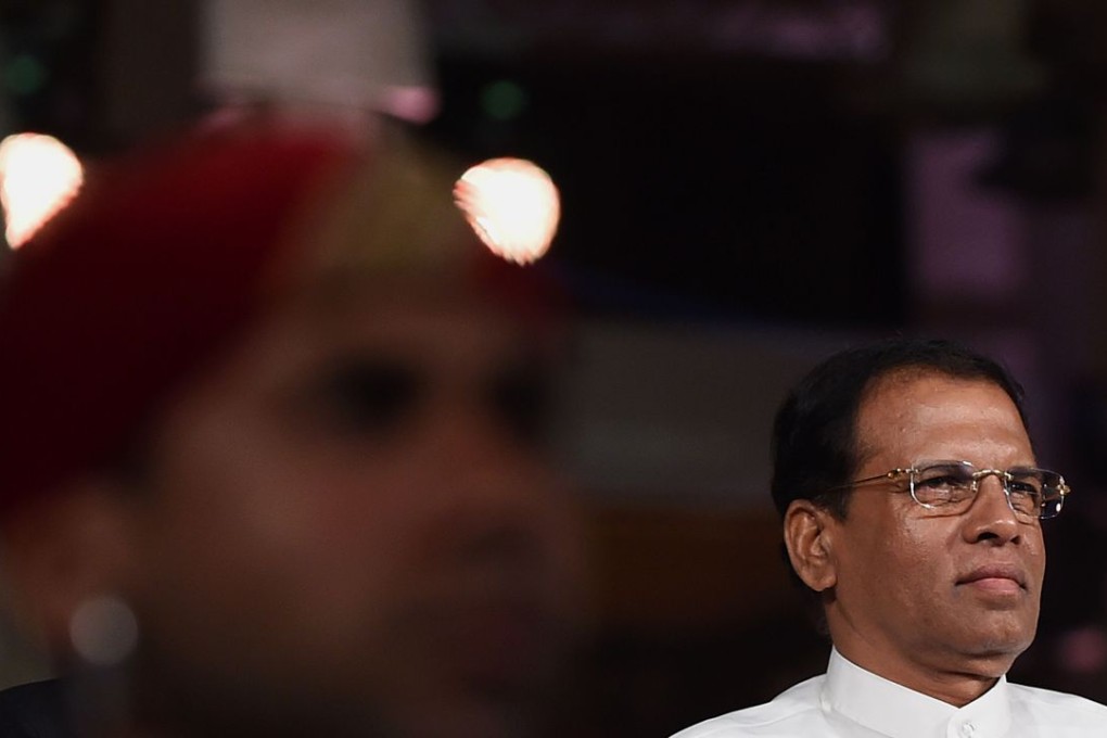 Sri Lanka's President Maithripala Sirisena (right) watches a cultural show at Independence Square in Colombo on January 9, 2016. Sirisena marked his first year in office with a pledge to introduce sweeping constitutional reforms aimed at preventing the island returning to ethnic war. Photo:AFP