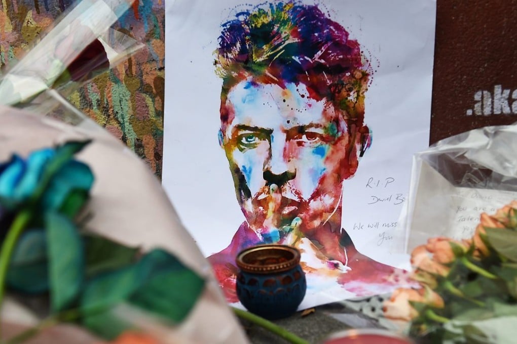 Well-wishers have flocked to the David Bowie mural to pay their respects following the announcement of his death. Photo: EPA