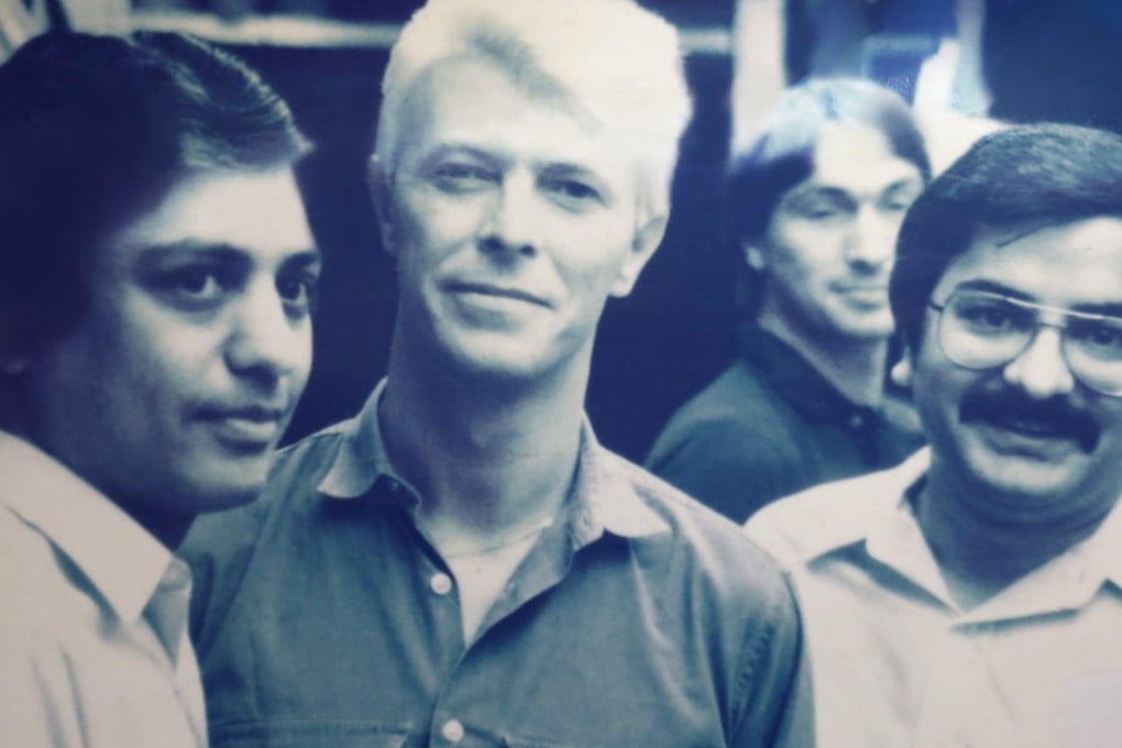 (L-R) Manu Melwani, David Bowie and Sham Melwani in a photo hanging at Sam’s Tailors in Tsim Sha Tsui. Photo: Jonathan Wong