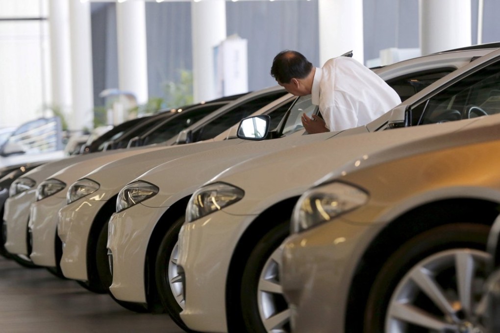A man looks at second-hand BMW cars at a dealership in Beijing. The 24.6 million new cars sold last year was a record for the mainland but represented the smallest annual growth since 2012. Photo: Reuters