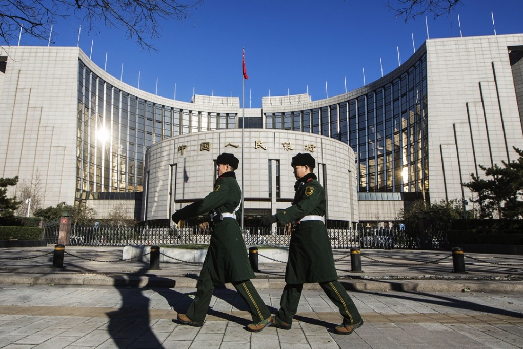 People's Liberation Army guards walk past the People's Bank Of China headquarters in Beijing on December 2. China's great rebalancing - the long-sought shift away from investment and manufacturing towards consumption and services - was one of the big themes of 2015, but now the nation is taking flak for its protectionist policies aimed at bolstering its tech sector. Photo: Bloomberg