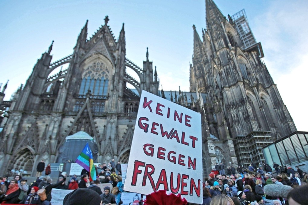 A demonstrator holds a sign in German that reads ‘No violence against women’ during a demonstration in the wake of the sexual assaults on New Year’s Eve, outside the cathedral in Cologne. Photo: EPA