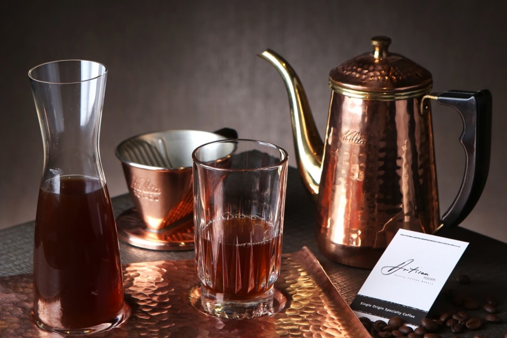 Single-origin coffees are served in a bottle and glass on a handmade copper tray at Artisan Room in Shek Tong Tsui.