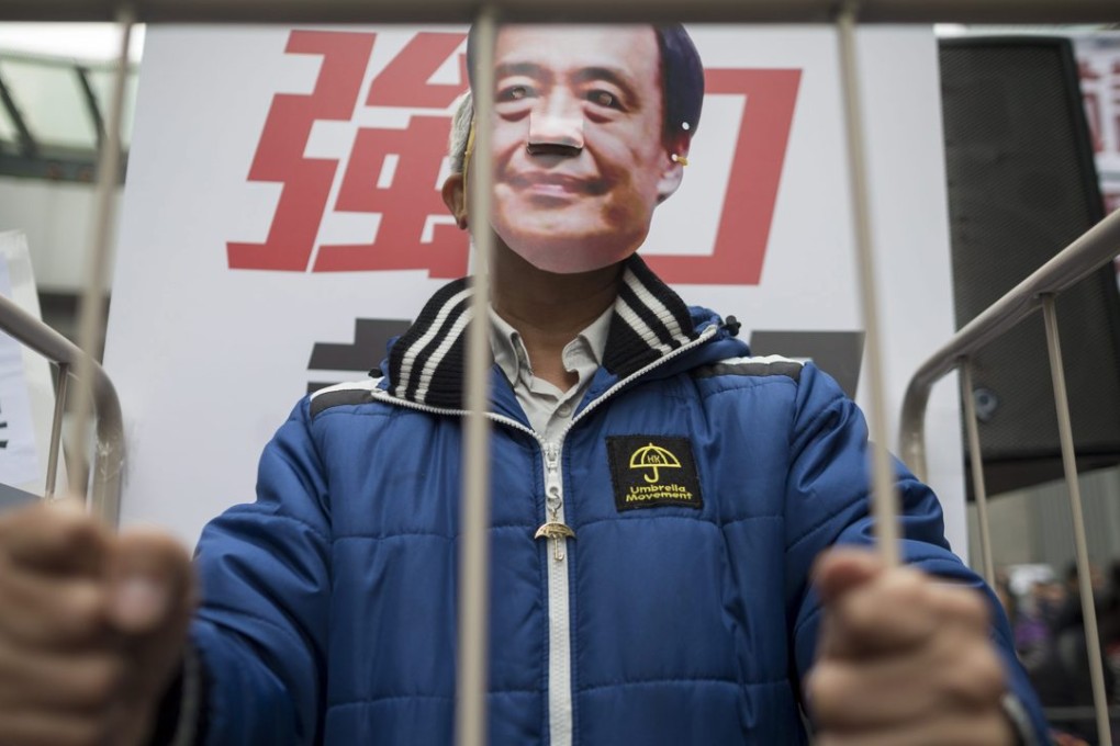A protester at a rally in Hong Kong on Sunday wears a mask of missing bookseller Lee Bo. Photo: EPA