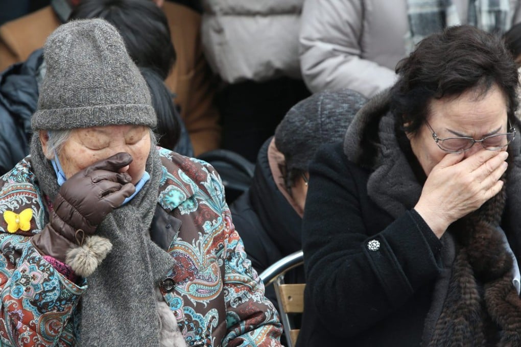 Former South Korean 'comfort women' Gil Won-ok (left) and Lee Young-soo, forced to serve the Japanese army as sex slaves during the second world war, shed tears during a weekly rally near the Japanese embassy in Seoul. Photo: EPA