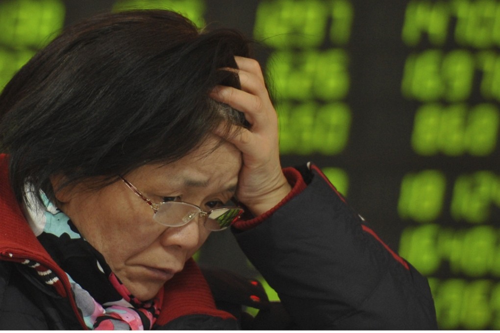 A woman reacts as she checks stock prices at a brokerage house in Fuyang, Anhui province, on Monday. Photo: AP
