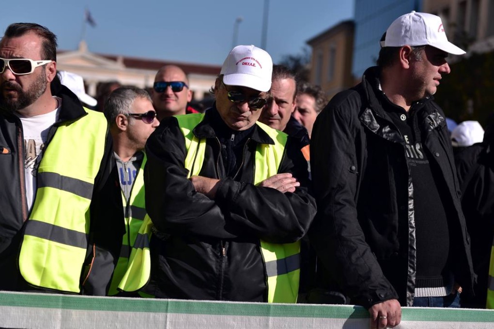 Dock workers participate in a rally in central Athens last month against the sale of Greece's main port in Piraeus. Photo: AFP