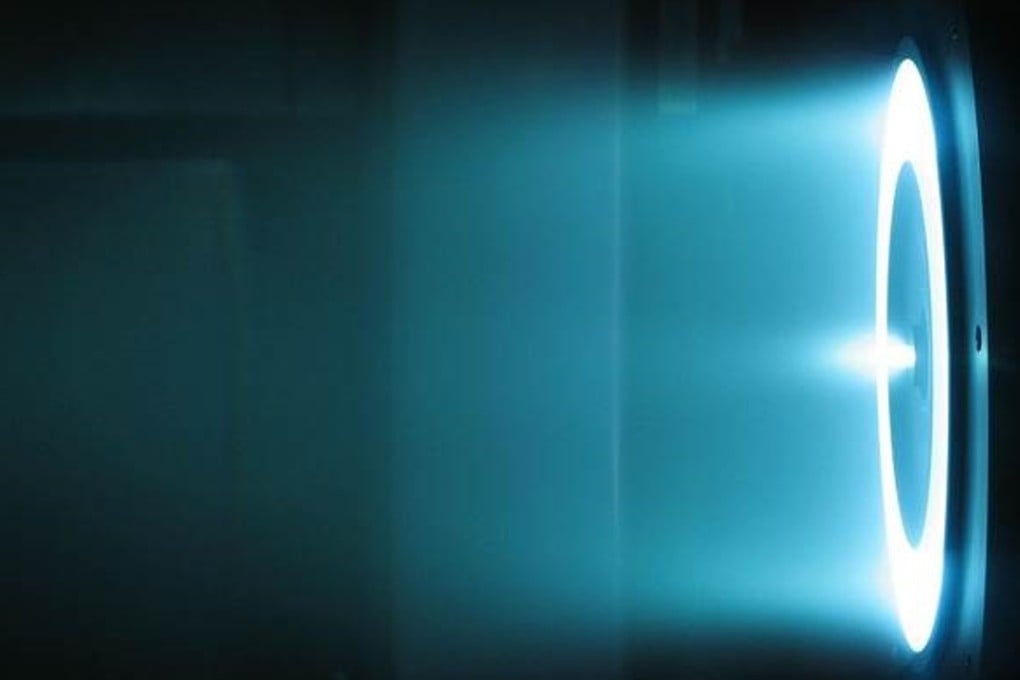 This image shows the exhaust produced by a 6 kW Hall thruster at the Nasa Jet Propulsion Laboratory in California. Unlike rockets that rely on chemical propulsion, the ion thrusters use electricity to create an electromagnetic field to produce thrust. As the ionised particles leave the aircraft, they generate a force in the reverse direction. Photo: Nasa