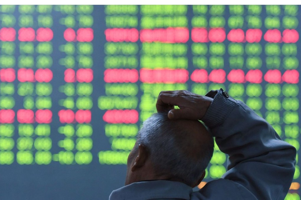 An investor sits in front of a screen showing stock market movements at a securities firm in Hangzhou,China. Chinese stocks dropped further Thursday morning, as worries linger over the economic outlook. Photo: AFP
