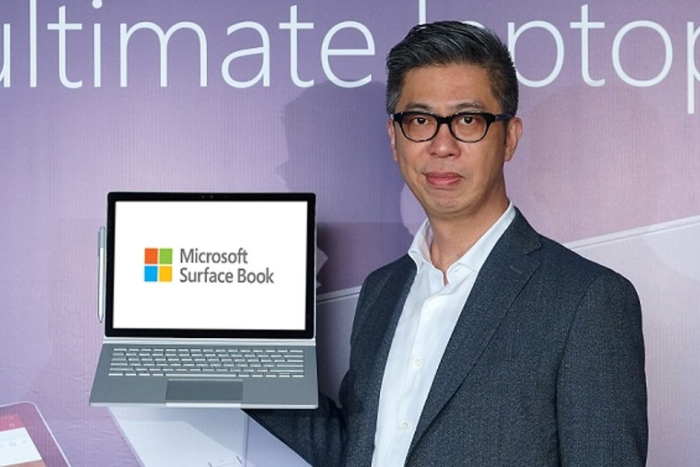 Chester Wong, director of Microsoft Hong Kong’s consumer channel group, holds up a Surface Book at a launch event in Hong Kong on Thursday. Photo: Handout