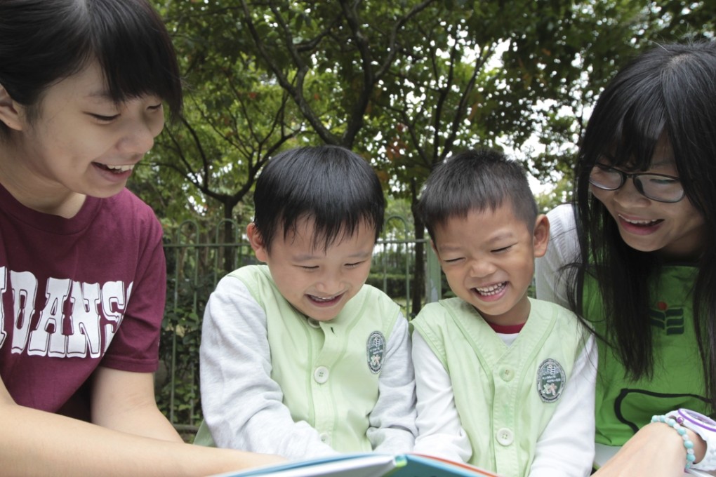 (L to R) Jamie Cheung, Hayden Chan, Nathan Lam and Stella Lau, read a book during a kindergarten class at the Hong Kong Institute of Education in Tai Po.