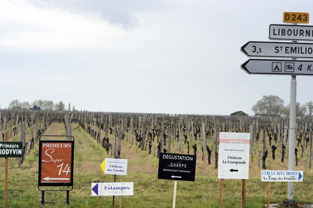 Signs indicate the tastings that take place in Saint-Émilion as part of the annual futures sale. Photo: AFP