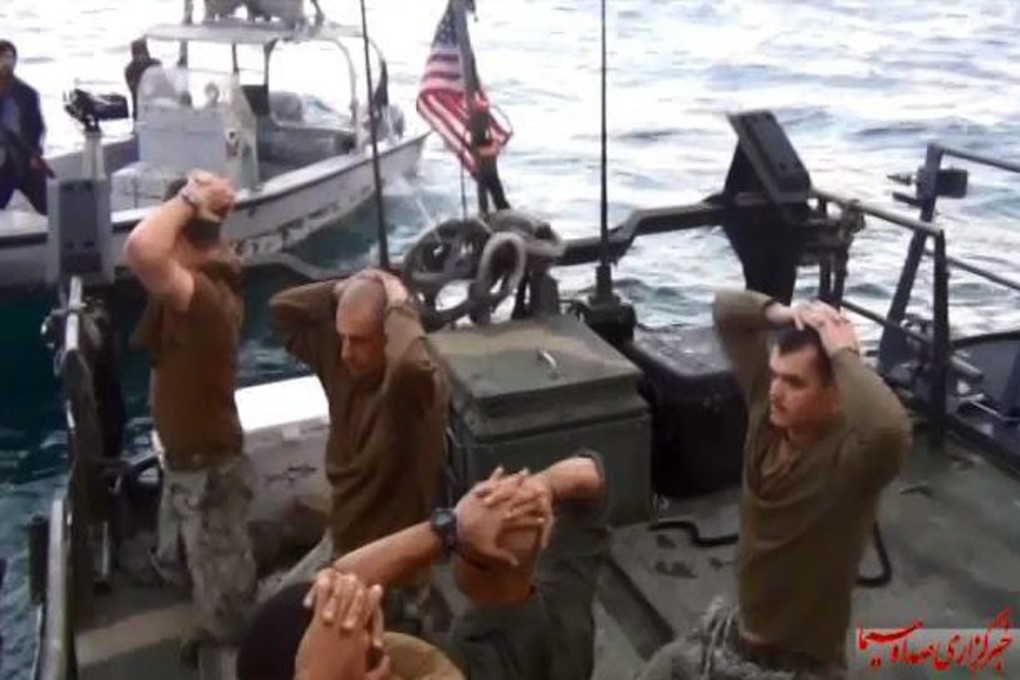 An image taken from a video made available by Iranian state television on Wednesday shows US sailors with their hands laced over their heads, apparently surrendering to Iranian Revolutionary Guards. Photo: EPA