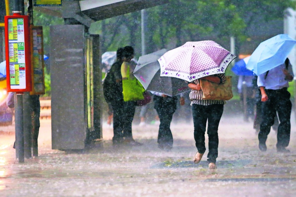 Huddling from the heavy rain in Admiralty last year. Photo: SCMP