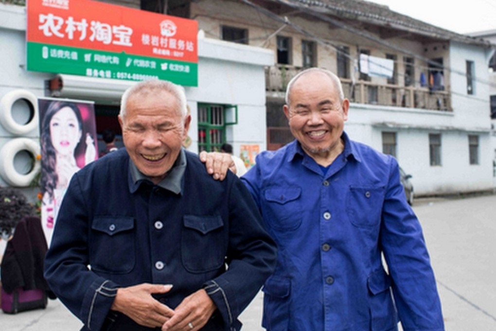 Two elderly men stand in front of a ‘Rural Taobao’ workstation in Louyan village of Fenghua, Zhejiang province last month. China’s Alibaba is moving to capitalise on the largely untapped e-commerce market in China’s less developed regions. Photo: Handout