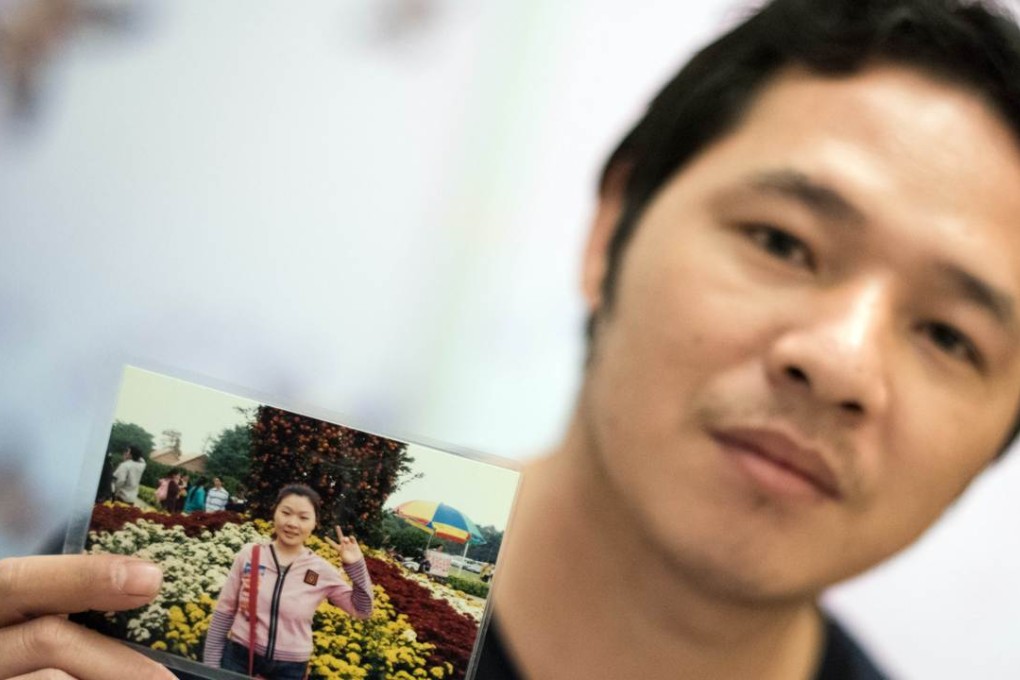 Wu Rongpu holds a picture of his wife Zhu Xiaomei, a labour activist who was arrested in Guangdong. Photo: AFP