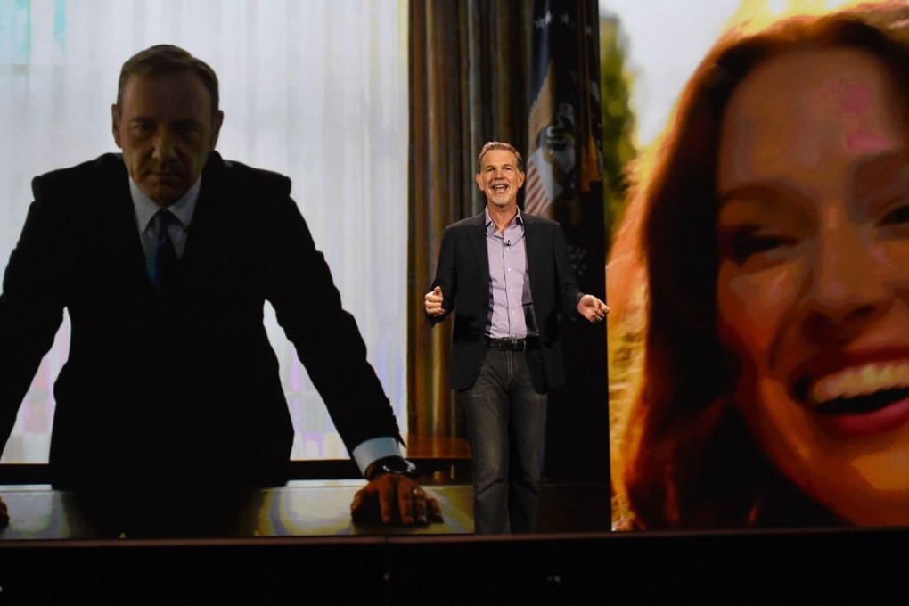Netflix CEO Reed Hastings delivers a keynote address in front of an image of actor Kevin Spacey (left) from "House of Cards" and an image of actress Ellie Kemper from "Unbreakable Kimmy Schmidt" at CES 2016 in Las Vegas on January 6. Photo: AFP