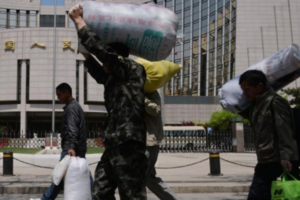 A file picture of migrant workers on the move in Beijing. Millions without the right residence permits in China have no access to basic services such as health care and education. Photo: AFP
