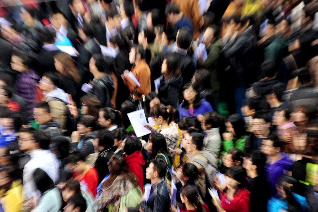 Fresh graduates swarm a job fair at Northeastern University in Shenyang. Throughout Asia, many workers feel they are over- or undereducated for their jobs, while employers often lament a lack of qualified graduates. Photo: Xinhua
