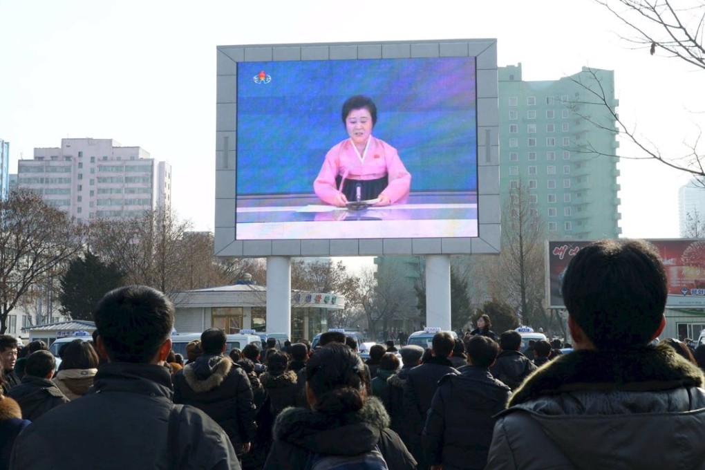 People in Pyongyang watch a huge screen broadcasting the government's announcement of its nuclear test on January 6, 2016. Photo: Kyodo