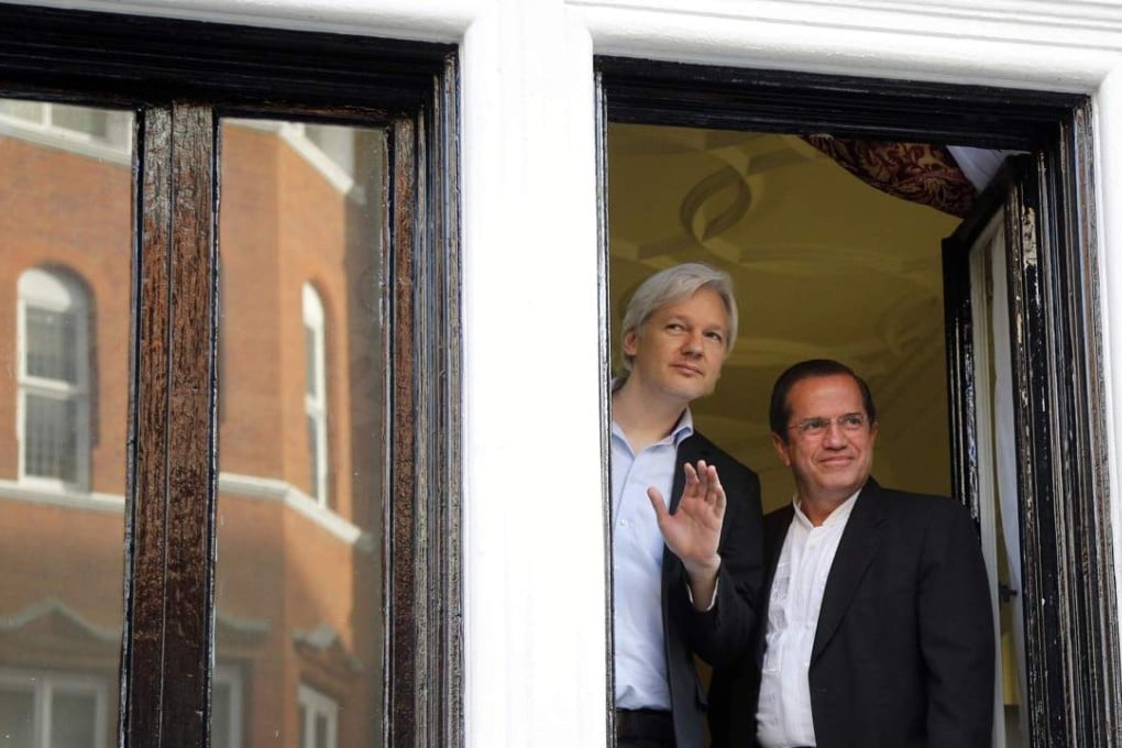 WikiLeaks founder Julian Assange (left) waves from a window with Ecuador’s Foreign Affairs Minister Ricardo Patino at Ecuador’s embassy in London on June 16, 2013. Photo: Reuters