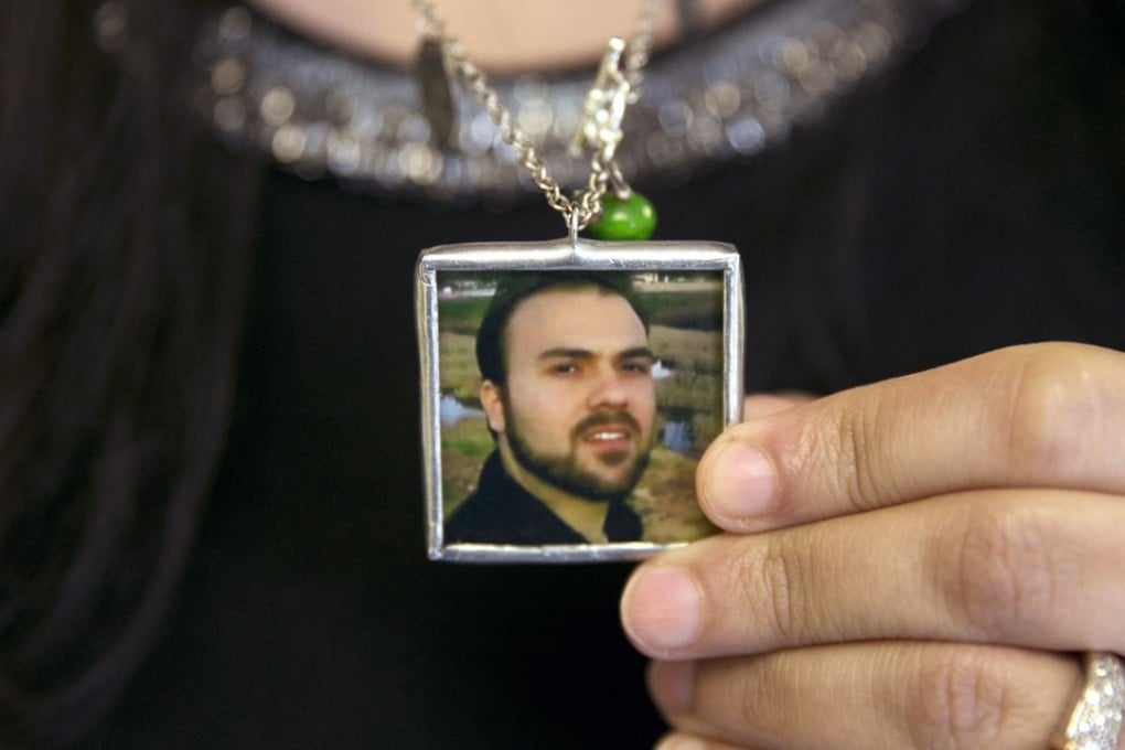 Naghmeh Abedini holds a necklace with a photograph of her husband, Saeed Abedini, one of the prisoners released by Iran. Photo: AP