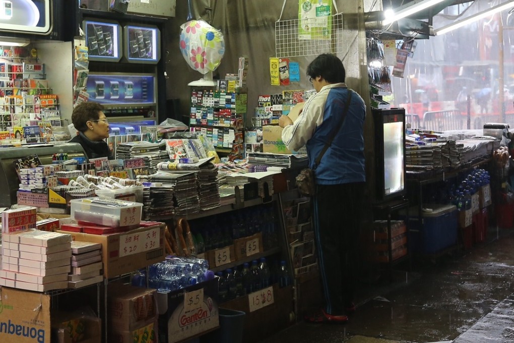Chu Yuet-han, 62, has sold papers here for the past four years, and says her business will be halved today as marathon runners jog past. Photo: Dickson Lee