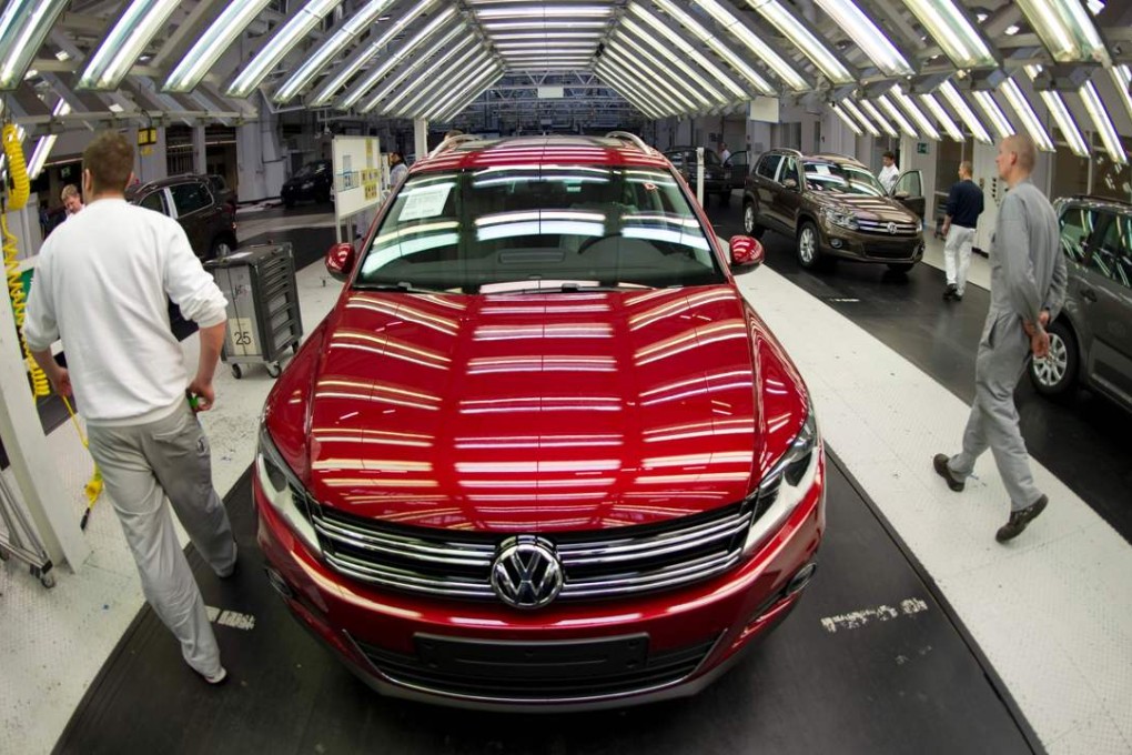 Volkswagen workers inspect cars coming off the assembly line in Wolfsburg, Germany. Photo: AFP