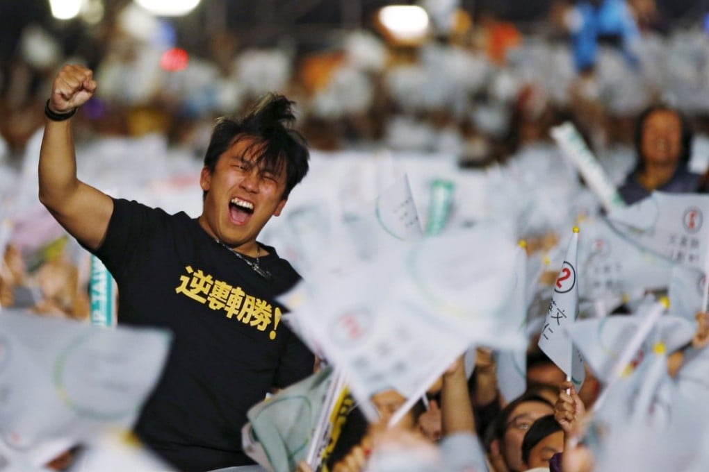A supporter of successful presidential candidate Tsai Ing-wen celebrates as preliminary results are announced at their party headquarters in Taipei. Photo: Reuters
