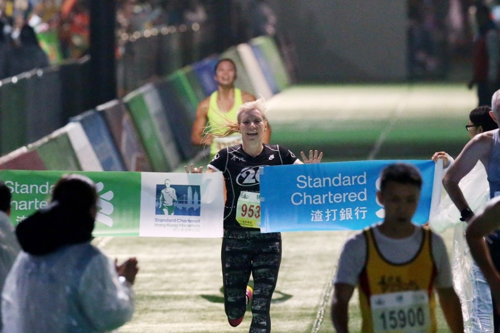 Kate Rutherford crosses the line to take the Women’s 10km race. Photo: Nora Tam