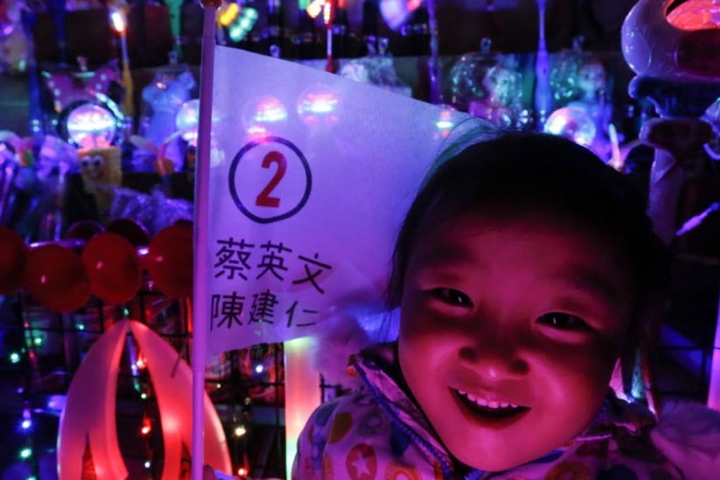 A young supporter of Taiwan’s Democratic Progressive Party (DPP) holds up a flag with the name of presidential candidate Tsai Ing-wen during a campaign rally for the 2016 presidential election in Kaohsiung, Taiwan. Photo: EPA