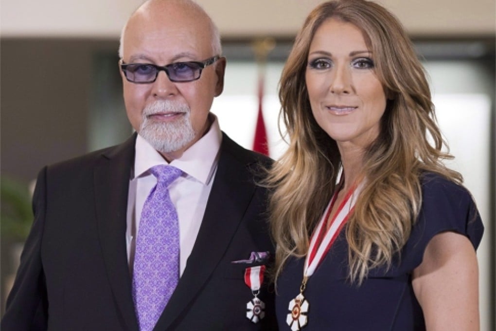 File- This July 26, 2013, file photo shows Canadian music star Celine Dion, right, and husband Rene Angelil posing for photos after being decorated with the Order of Canada in Quebec City. Authorities say Angelil, the husband and manager of Dion, has died in Las Vegas. He was 73 and had battled throat cancer. Clark County Coroner John Fudenberg said his office was notified Thursday, Jan. 14, 2016, of Angelil’s death. (Jacques Boissinot/The Canadian Press, File)