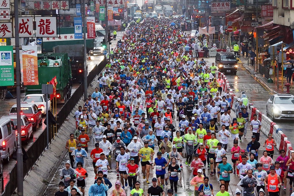 Hundreds of runners pass along Nathan Road in Mong Kok during yesterday’s Hong Kong Marathon. Photo: Dickson Lee