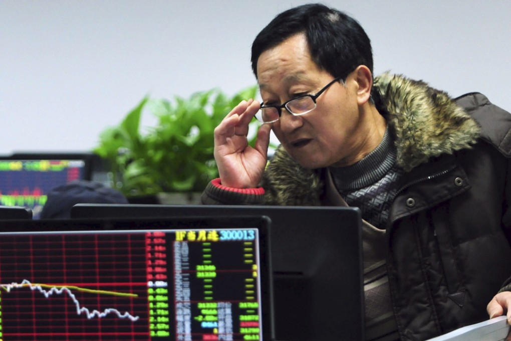 A Chinese investor checks stock prices on a computer terminal in a brokerage house in Jiujiang in central China's Jiangxi province. Photo: AP